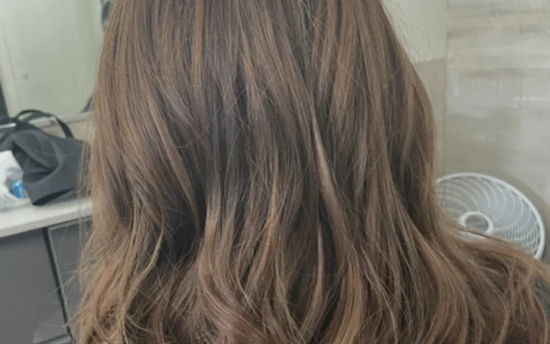 Soft layered haircut with a bouncy blowout finish by Erica Wilson