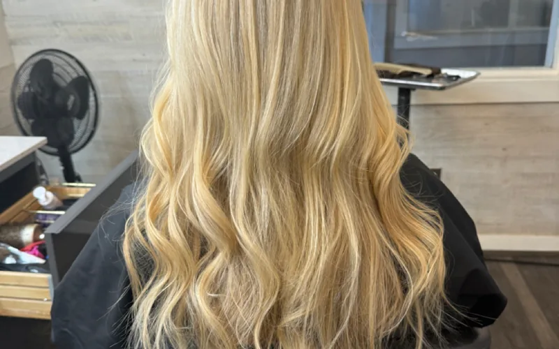 Long, full blonde waves with added length and volume by Erica Wilson