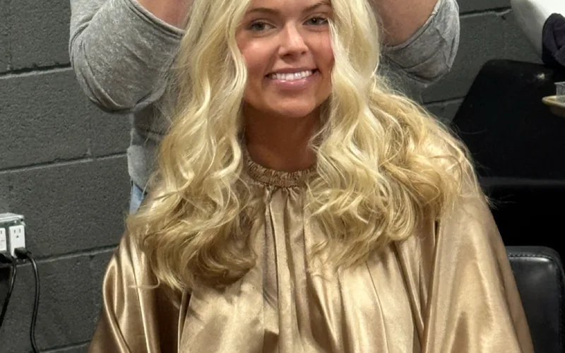 A smiling guest in the chair mid-appointment at Erica Wilson's Dallas salon